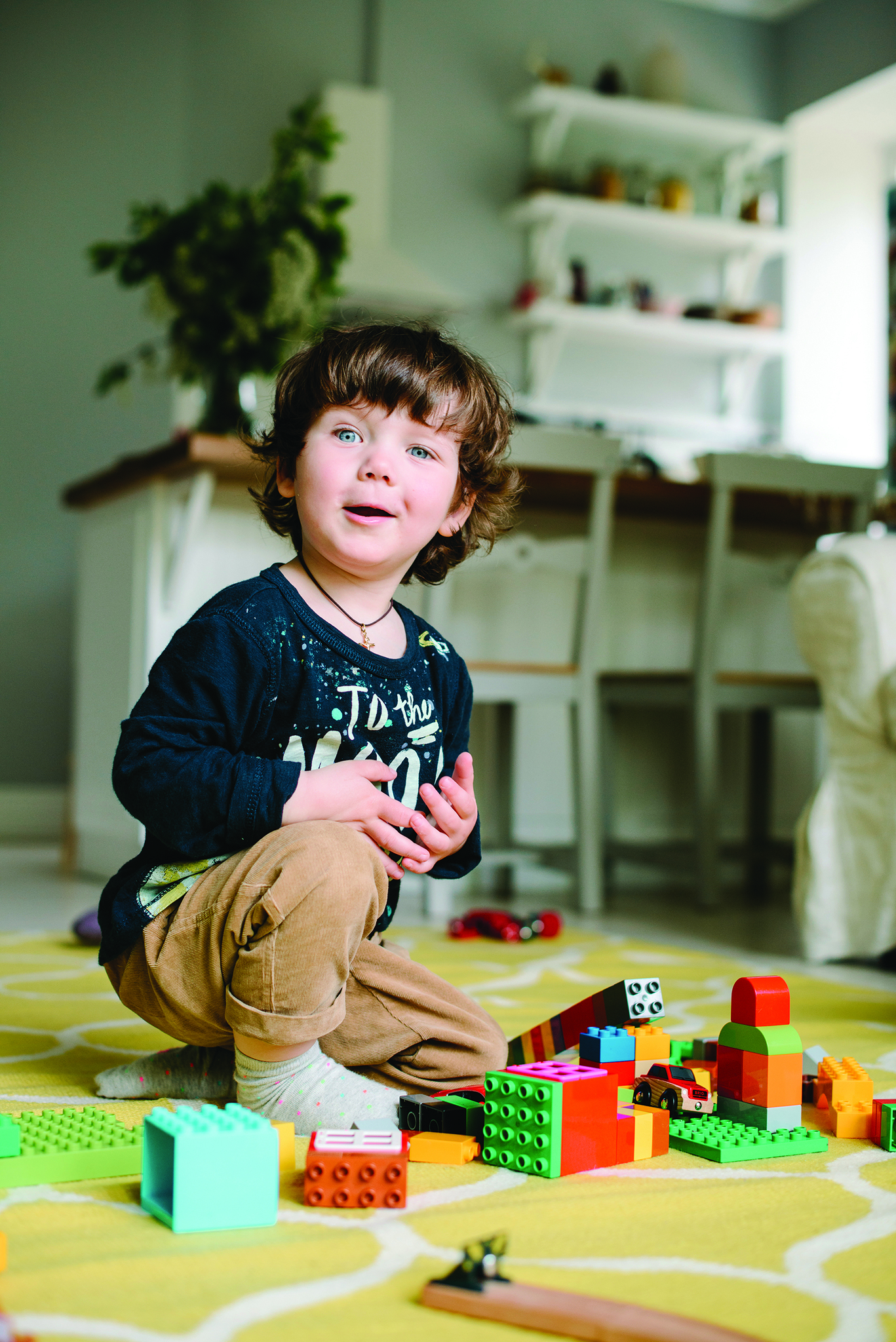 boy playing with legos
